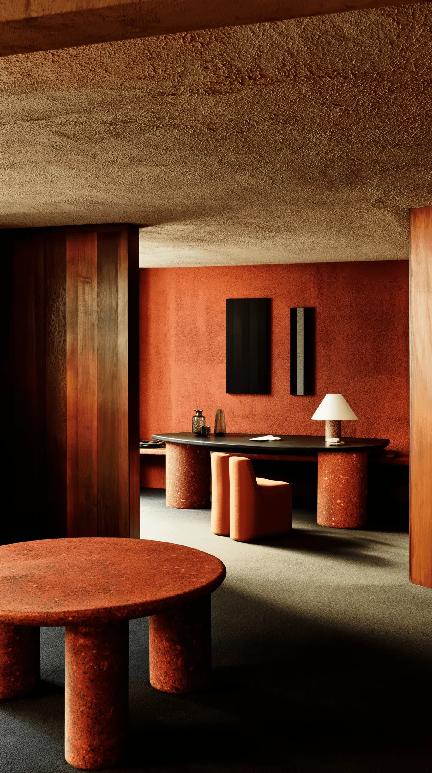 A terracotta-toned room with a curved plaster wall, a slim console and a low round table